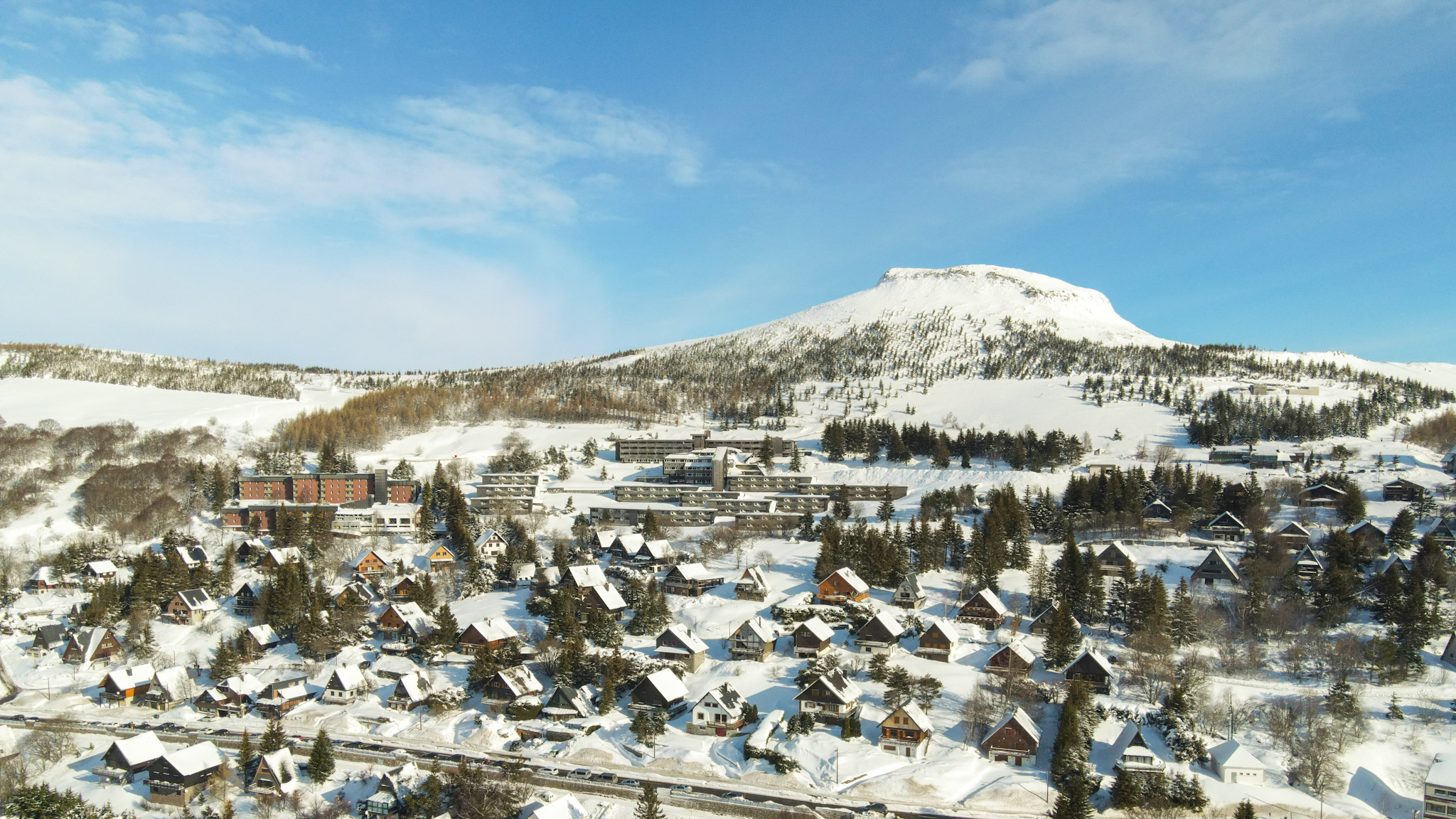 Super Besse vue du Ciel : Village de Chalets niché sur les Pentes du Puy du Chambourguet 